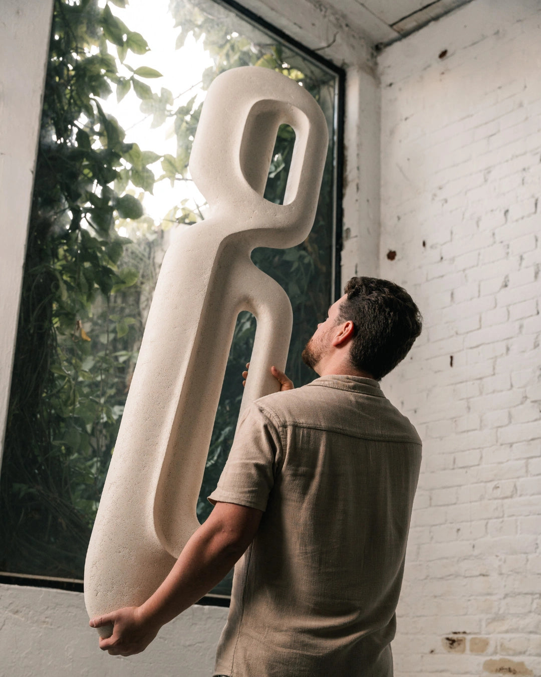 Escultura de parede Passante